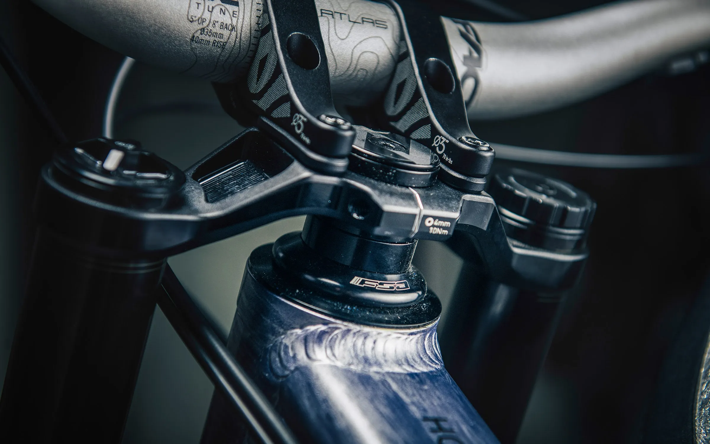 The fork crown, stem and handlebar above the Team DH's head tube