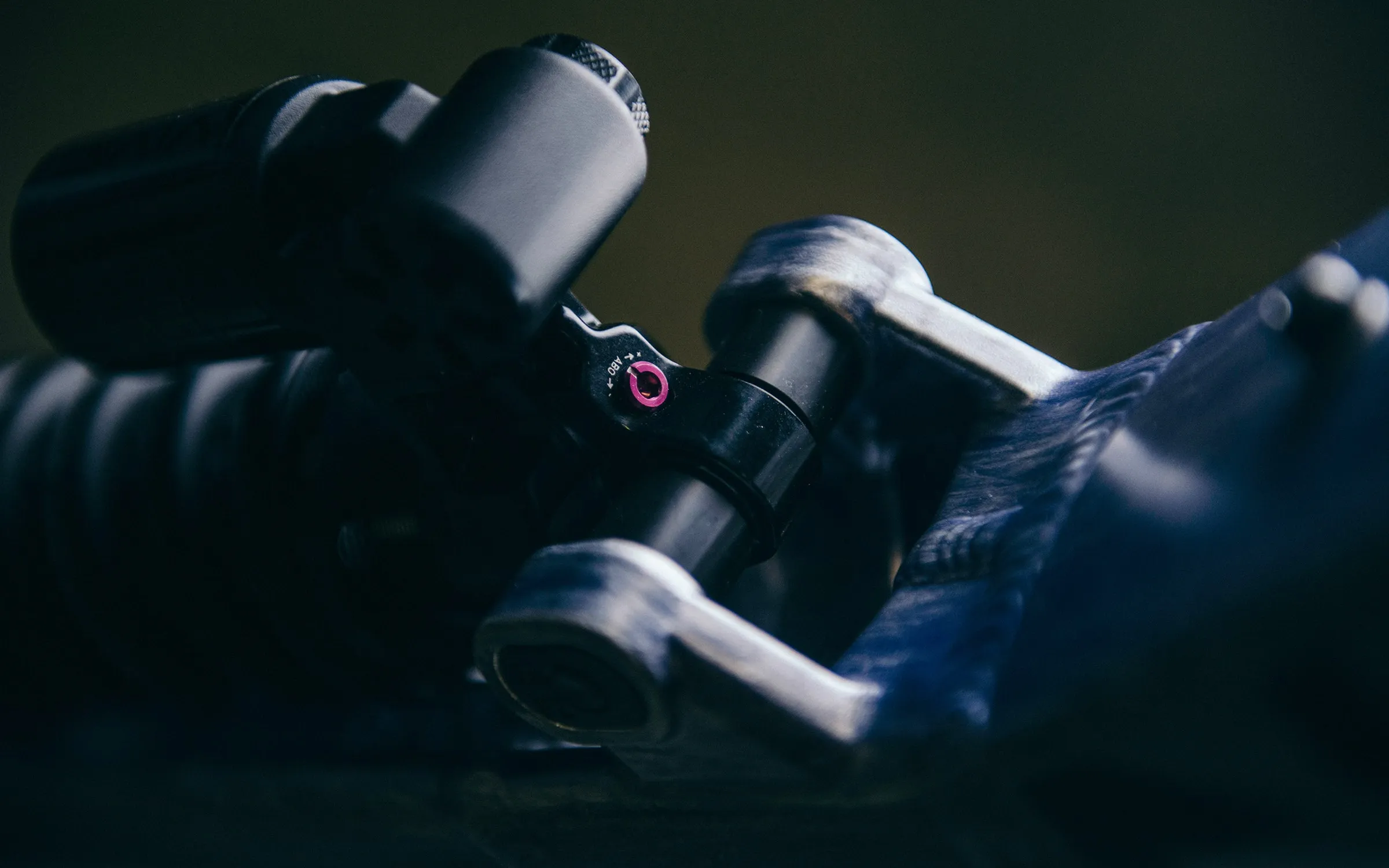 The rear shock's rebound adjuster and its lower mount in the rocker link