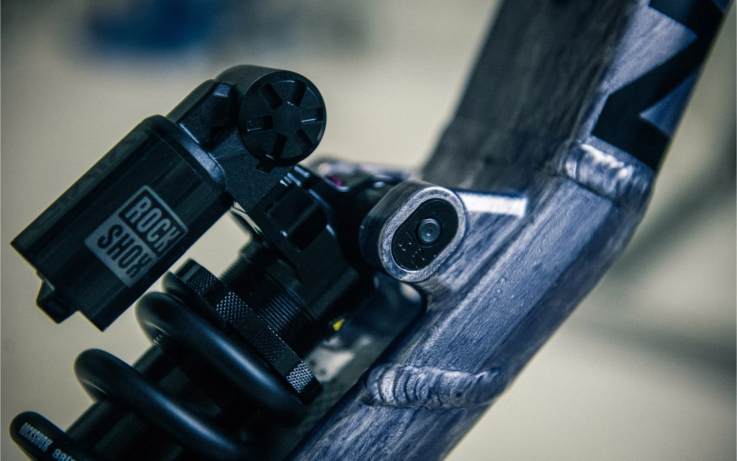 The rear shock's piggyback reservoir and compression dial where it meets the frame