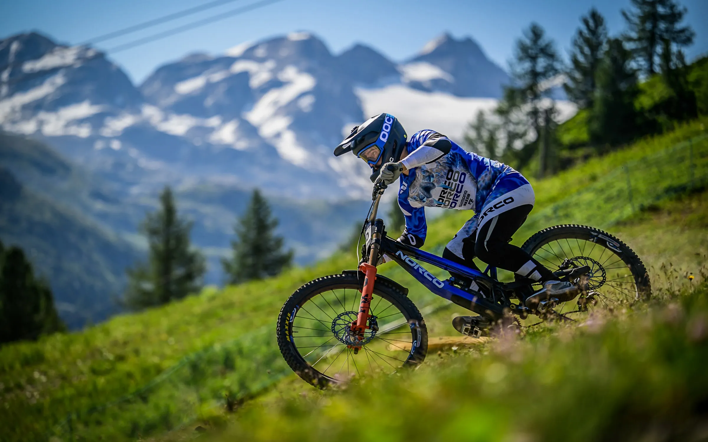 Bodhi Kuhn on the alpine track at La Thuile, snow-capped peaks behind
