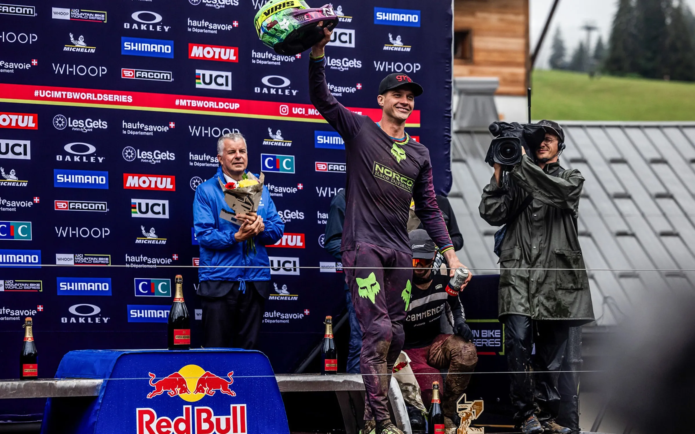 Greg Minnaar on the World Cup podium at Les Gets, photographers below