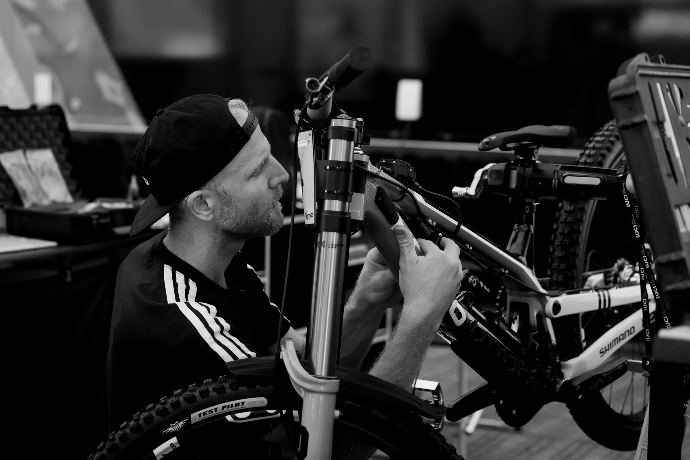 The Team DH's handlebar and fork crown seen head-on in a dim workshop